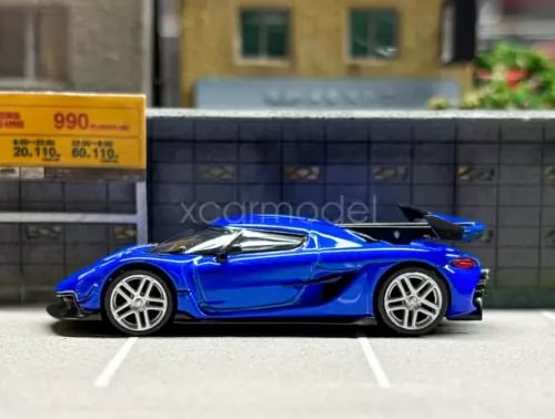 Blue 1:64 scale diecast sports car, side view with silver wheels