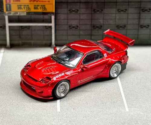Red JDM diecast sports car model with hood scoop and rear wing, open details.