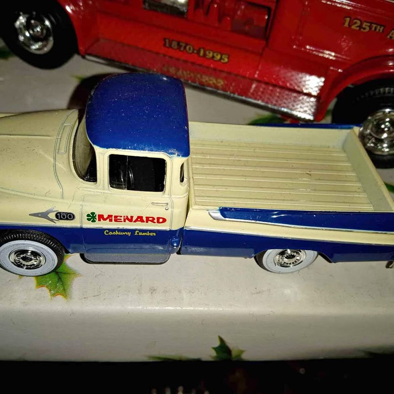 Vintage diecast car with cream body and blue roof, side view with wheels visible