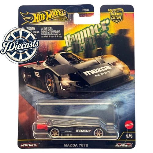 Mazda 787B diecast race car in blister package, black with orange details