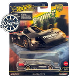 Mazda 787B diecast race car in blister package, black with orange details
