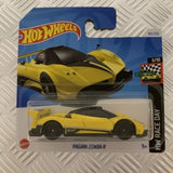 Yellow diecast sports car in clear blister pack, black wheels and rear spoiler