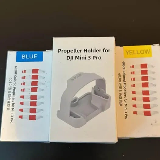 Grey propeller holder for DJI Mini 3 Pro, shown in retail packaging