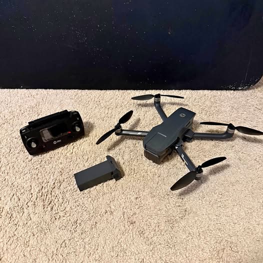 HS720G drone with dark gray body and black remote controller