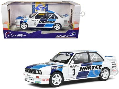White and blue BMW E30 M3 race diecast car model, #3 Hartege livery, front 3/4 view