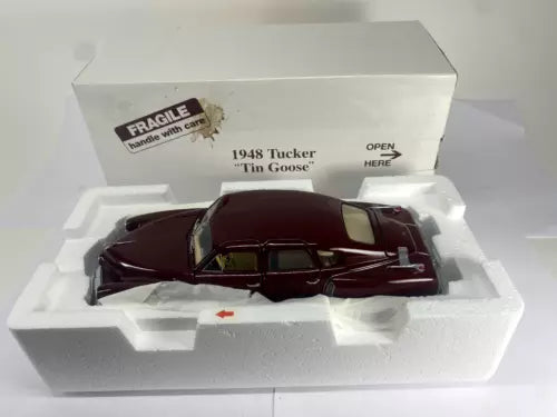 1948 Tucker Tin Goose tin diecast car, maroon body with white side stripe, open door.