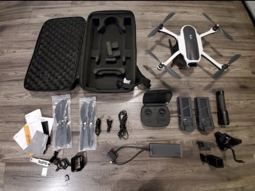 GoPro Karma drone with carrying case and accessories laid out, including controller and batteries