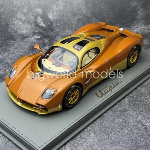 Copper 1/18 diecast sports car model with yellow accents, front 3/4 on display base