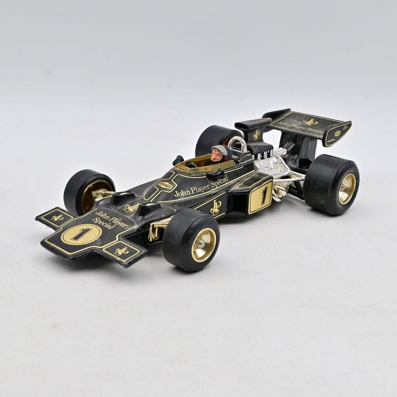 1:18 scale F1 diecast model car, black with gold accents and number 1