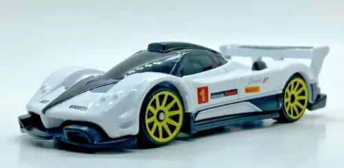 White race car diecast with yellow wheels, rear spoiler, number 1 decal