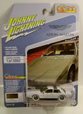 Gold Aston Martin Lagonda diecast car with white wheels, in blister packaging