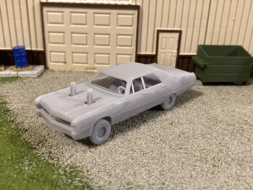 Miniature gray 3D printed demolition derby car with open roll bars, side view.