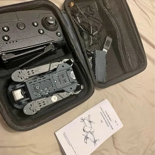 Drone kit in hard case with quadcopter frame and control module, plus manual