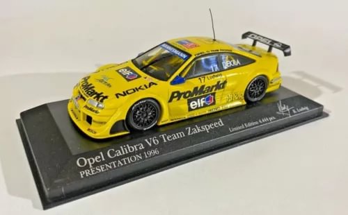 Yellow Opel Calibra diecast model car with display base, scale 1:43