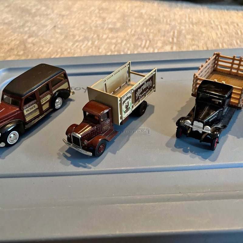 Set of 3 vintage diecast trucks with maroon, dark, and black cab beds