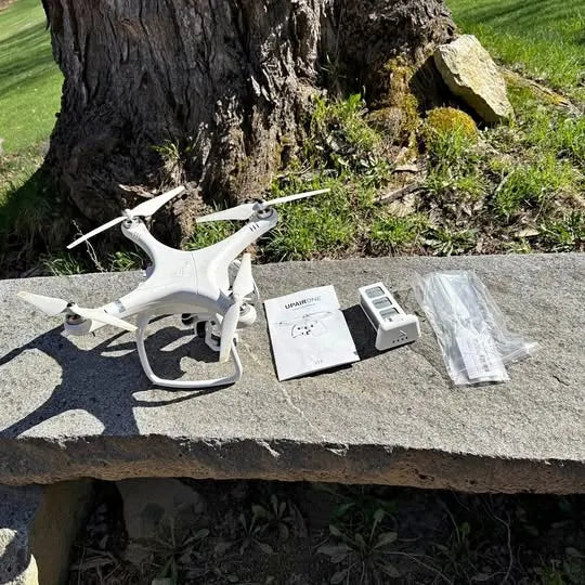 UPAIRINE V1.0 drone, white quadcopter with accessories kit on surface