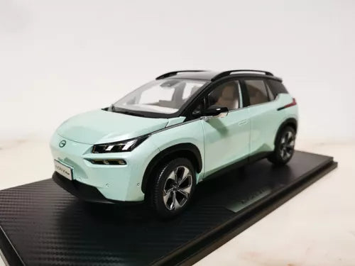 1:18 scale diecast car model in mint green with black roof and wheels