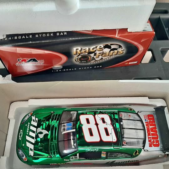 Green 1:24 scale NASCAR diecast stock car with #86 on the door