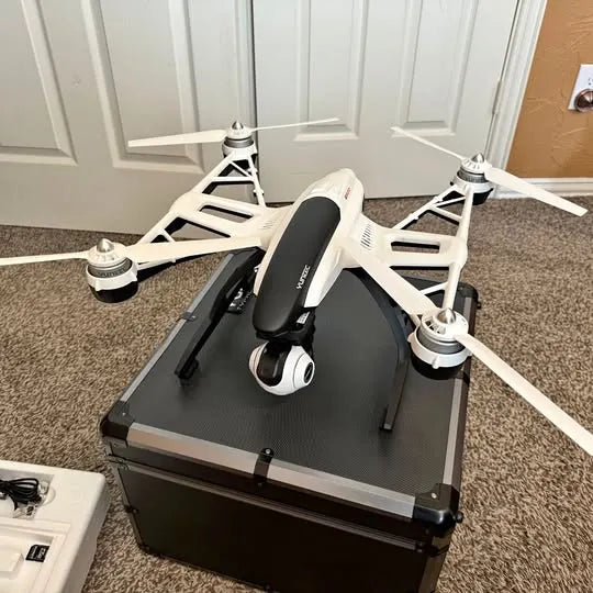 White quadcopter drone with mounted camera, landing platform, and four rotors