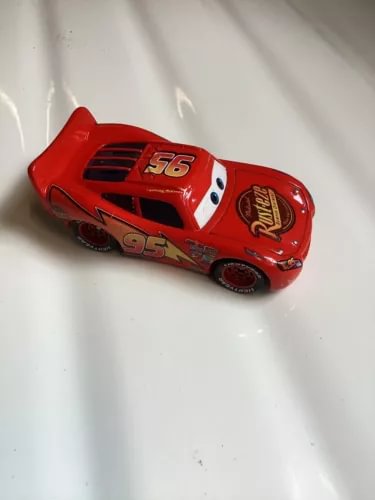 Red diecast race car with 95 and 56 decals, molded Lightning styling