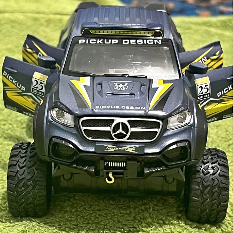 Diecast pickup truck model with off-road tires, front view, dark gray and black