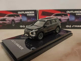 Black diecast SUV model with front three-quarter view on display base