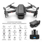 Foldable quadcopter drone with onboard camera, dark gray and black body, four rotors