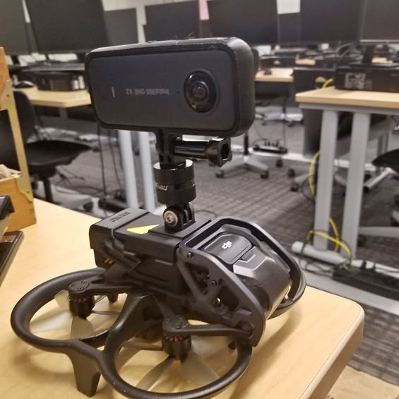 FPV drone with forward camera module and prop guards on front frame