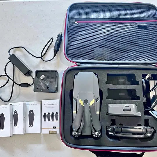 Foldable drone in hard zip case with battery and charging cables