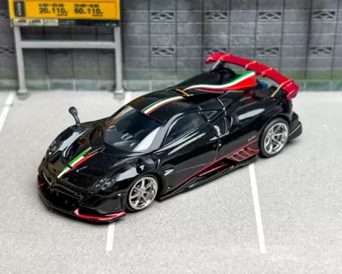 Black and red diecast sports model car with silver wheels, open cockpit detail