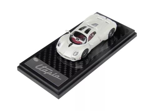 White diecast sports car coupe model on black display base, detailed body and wheels