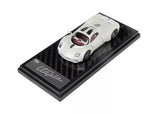 White diecast sports car coupe model on black display base, detailed body and wheels