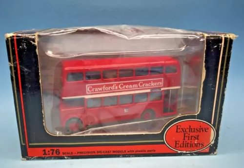 Boxed red die-cast double-decker bus model with Manchester City branding