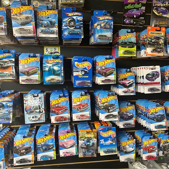 Hot Wheels diecast car lot, multiple boxed cars in assorted colors