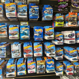 Hot Wheels diecast car lot, multiple boxed cars in assorted colors