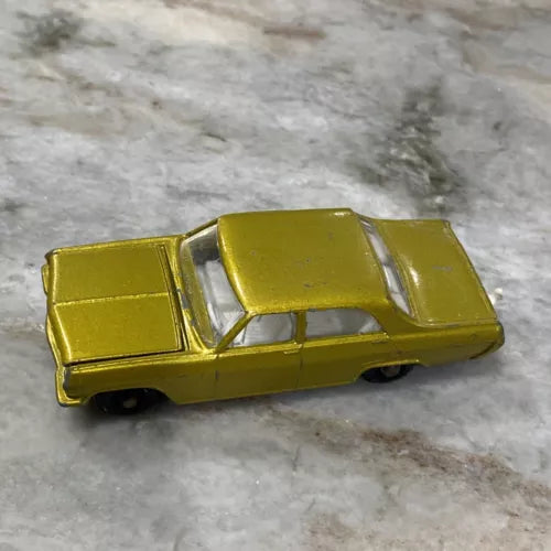 Gold 1:64 scale diecast car with open doors and molded detailing