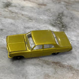 Gold 1:64 scale diecast car with open doors and molded detailing