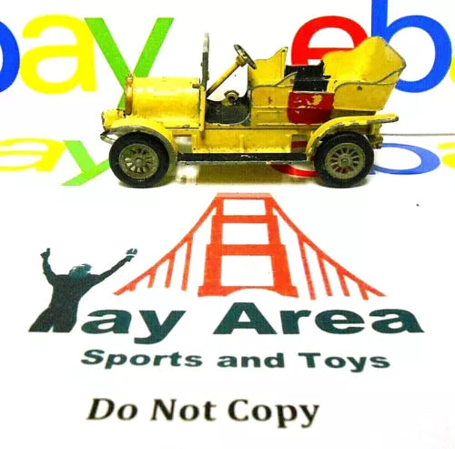 Yellow vintage diecast car model with open hood and red detail, side view