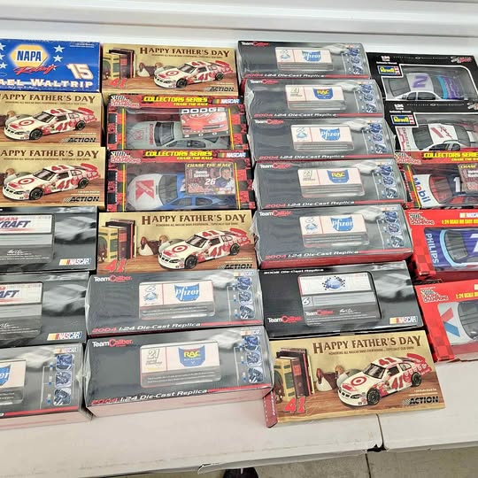 Boxed diecast toy car display with multiple racing model packages