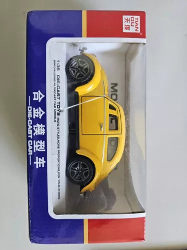 Yellow diecast toy car in blister box, black wheels, 1:36 scale