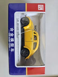 Yellow diecast toy car in blister box, black wheels, 1:36 scale