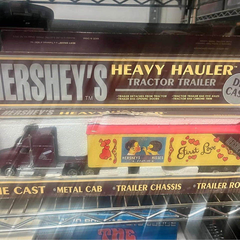 Diecast heavy hauler semi-truck toy with Hershey's trailer graphics and yellow side panel.