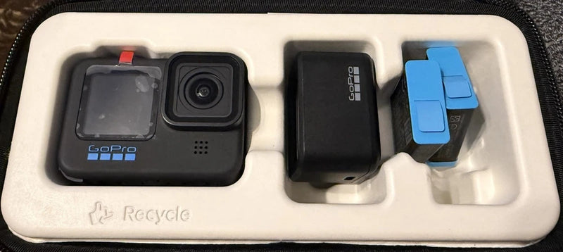 GoPro HERO10 action camera with front screen and foam tray accessories, including blue mount