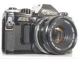 Canon AE-1 black film camera with FD 50mm f/1.8 lens, front view