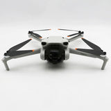 Dji Mini 3 drone with front camera and four white propeller arms