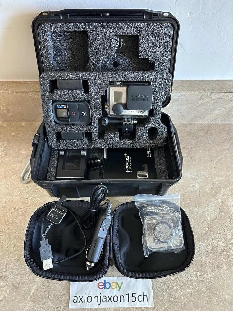 GoPro HERO3+ Plus black action camera in open case with mounts and cables