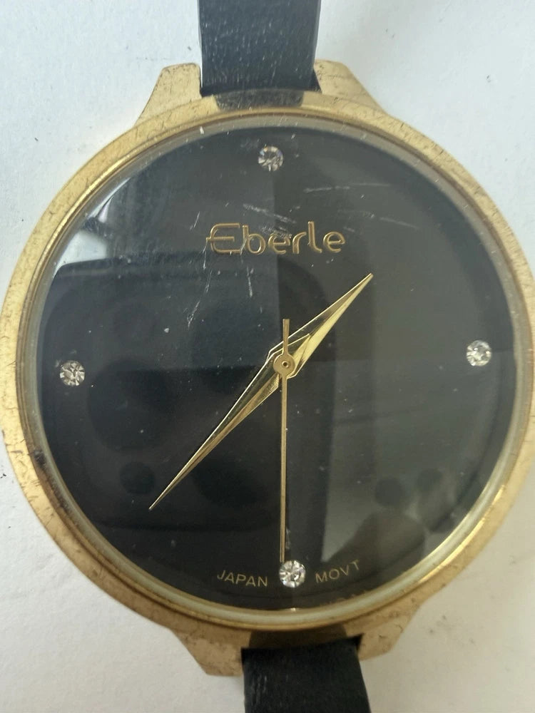 Gold-tone bezel Eberle watch with black dial, gold hands, bezel markers