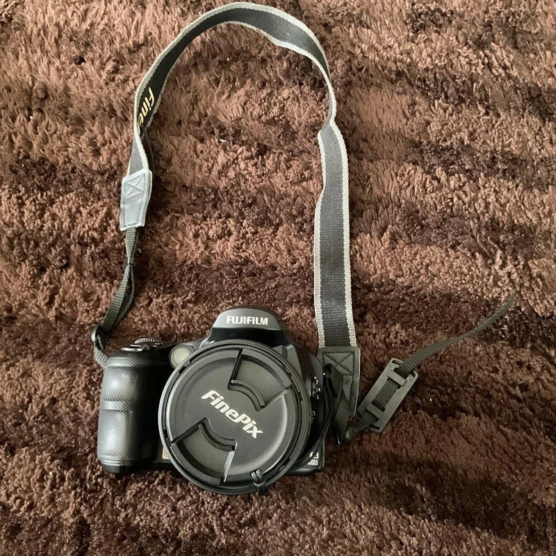 FUJIFILM FinePix digital camera with lens and attached carrying strap