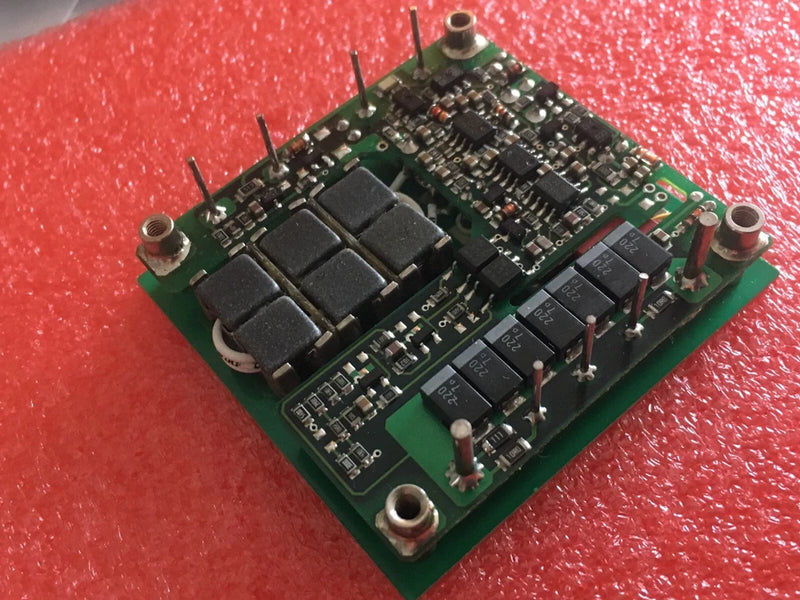 DC-DC converter module PCB with components and mounting holes on green board