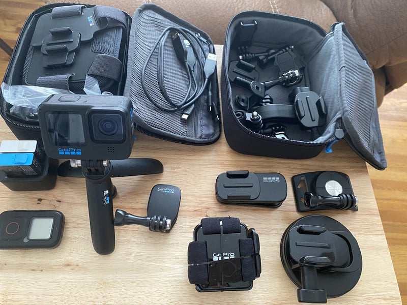 GoPro HERO10 action camera kit with open case, cables, mounts, and accessories